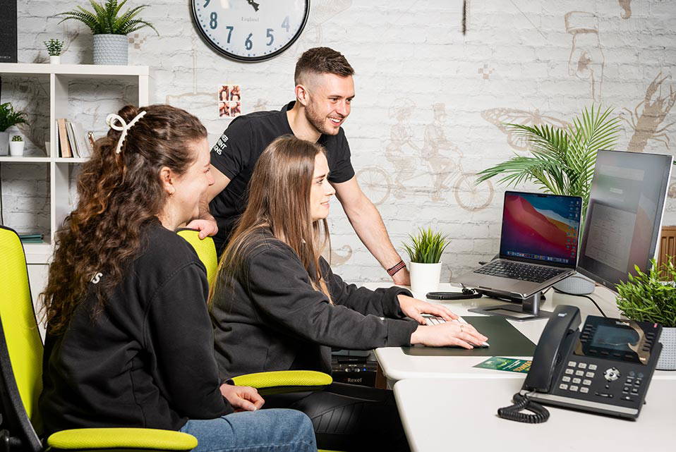 Three Nettl design specialists help create and elaborate on a design for a client.