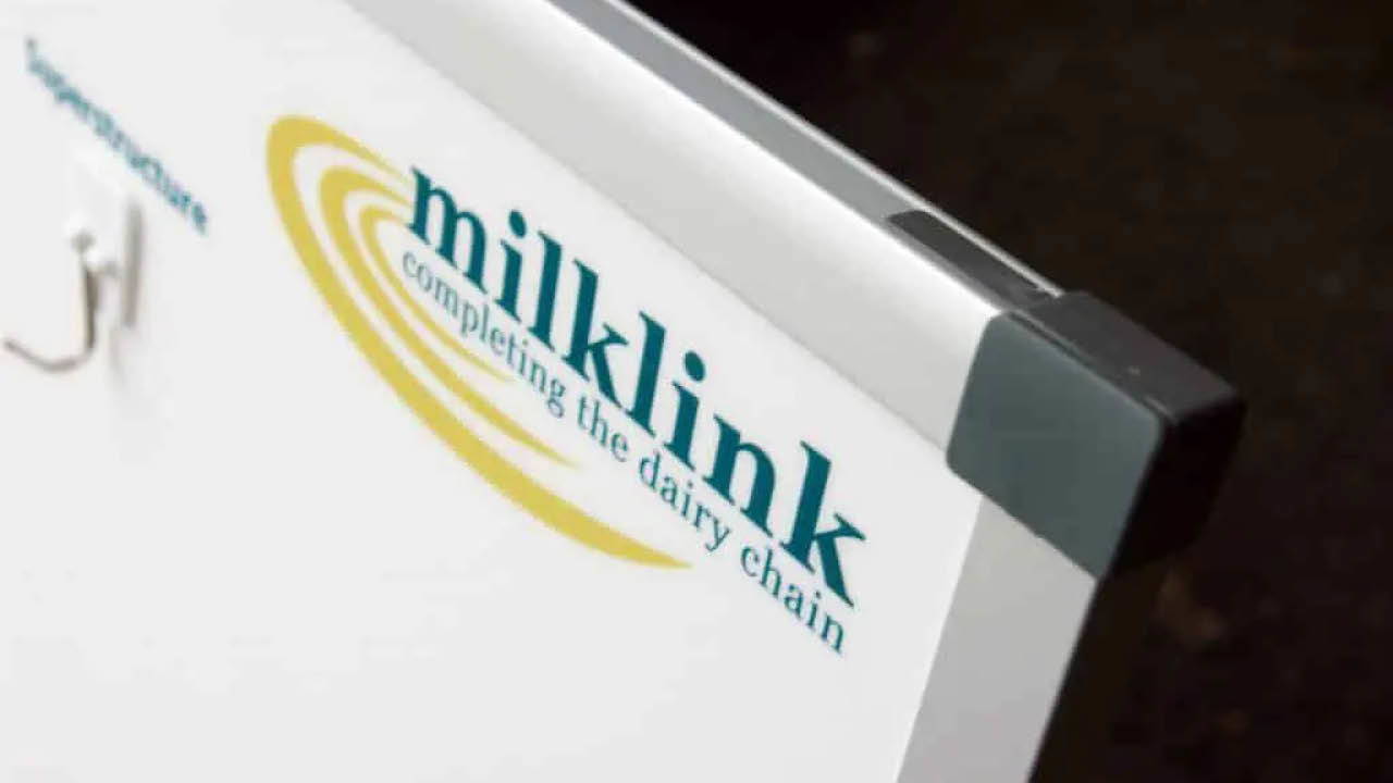 The corner of a whiteboard branded with a company's logo.