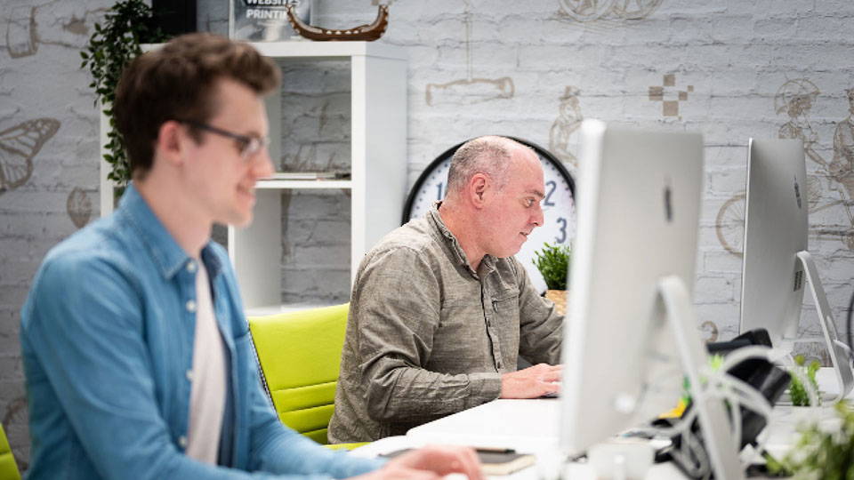 Two men working on design projects - graphic design Dublin