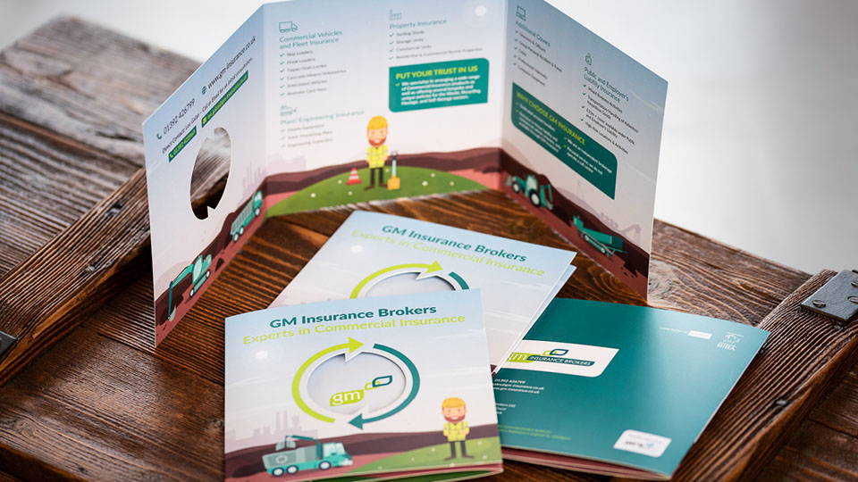 Multiple leaflets piled on top of each other, with an open leaflet displayed behind.