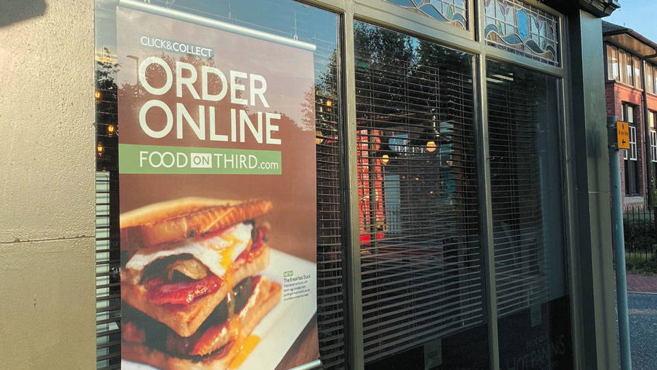 An image of three windscreens, with a poster displayed in the nearest window.
