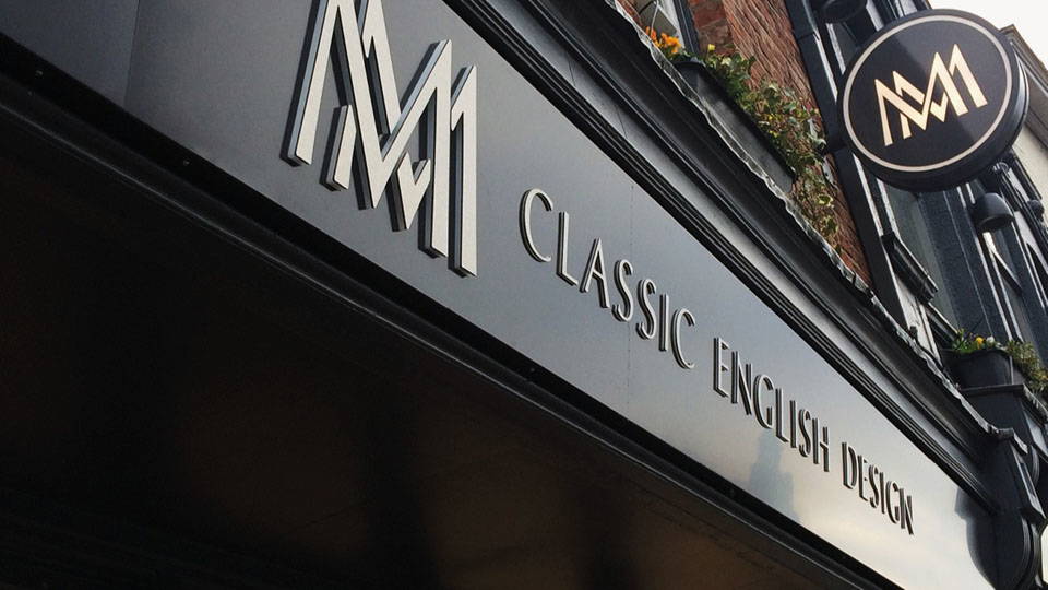 A clear image of a shop sign mounted onto a business.