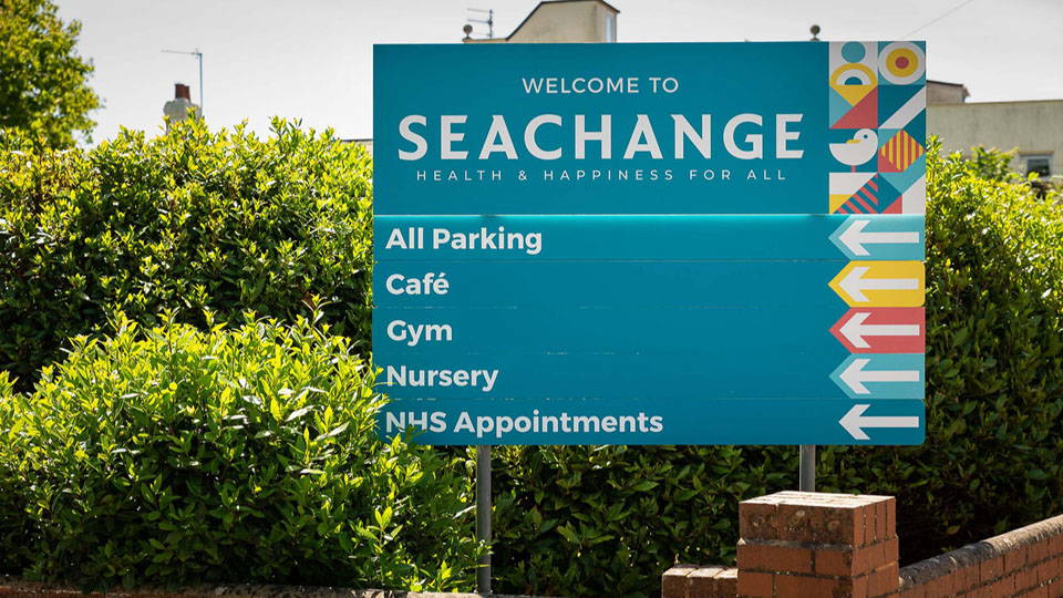 An image of a wayfinder sign with multiple locations and their direction.